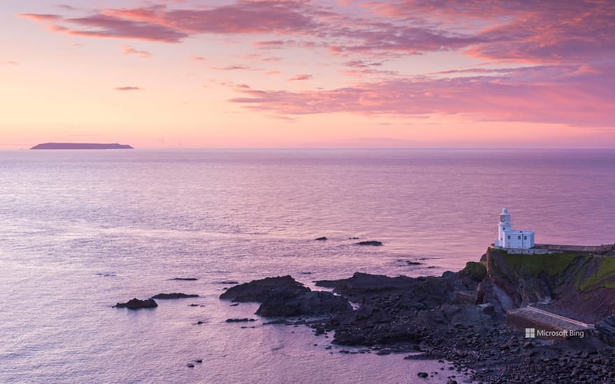 Hartland Point Lighthouse and Lundy Island beneath a colourful sunset, North Devon