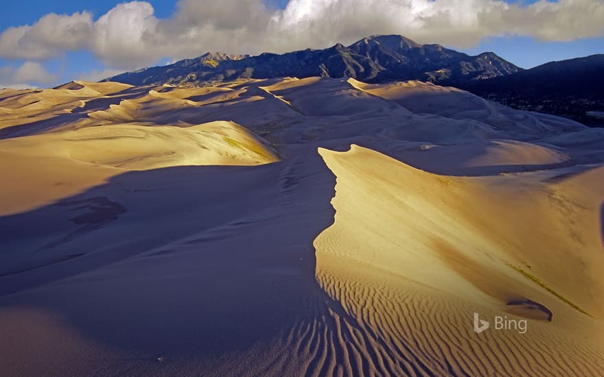 Sand dunes with the Sangre de Cristo Mountains in the background, Great Sand Dunes National Park and Preserve, Colorado